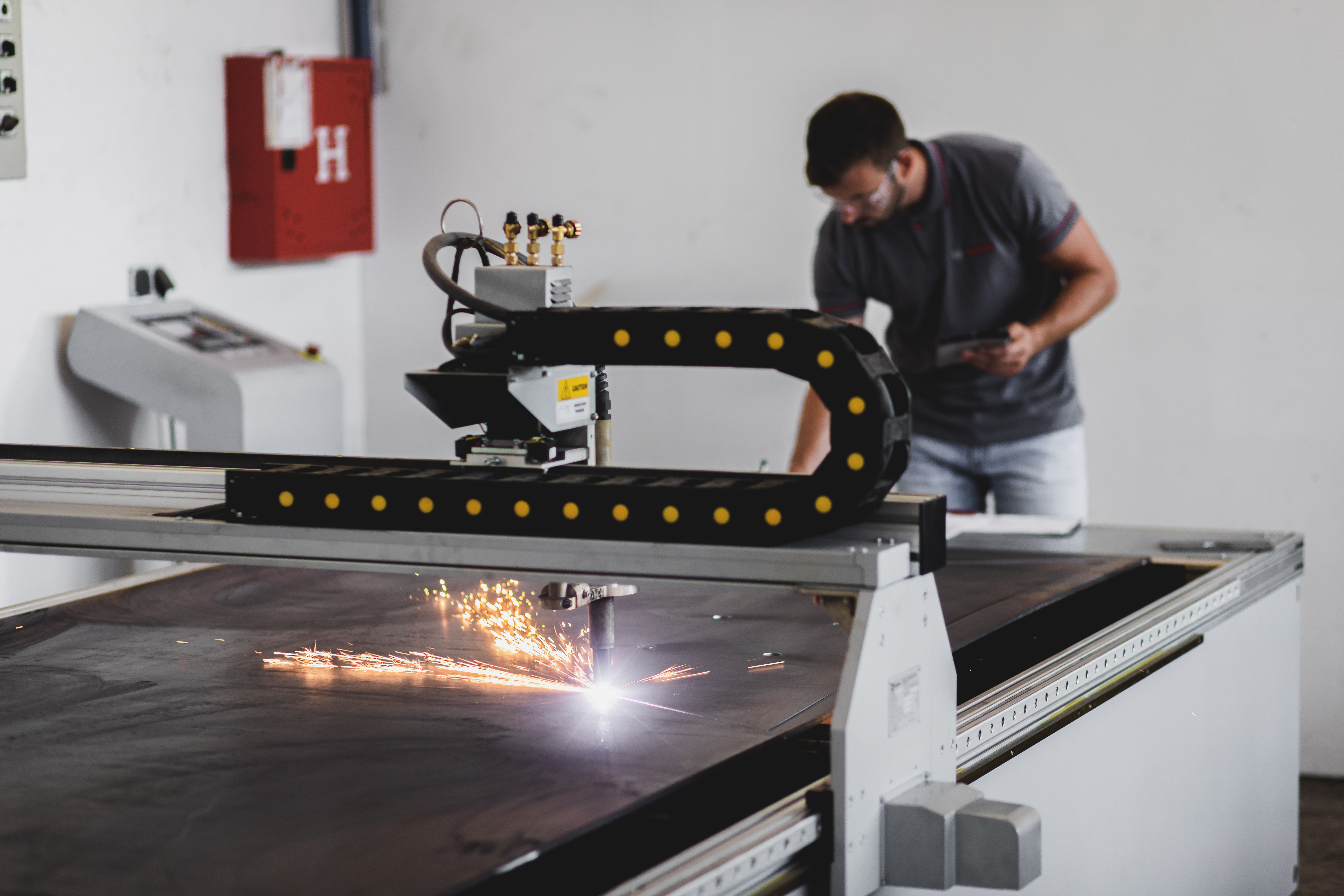 Cutting-Edge Quality: How Advanced Cutting Technologies Enhance Plastic Fabrication 3 young engineer setup plasma cutter for work in met f54b2e0c2b4c66d66077