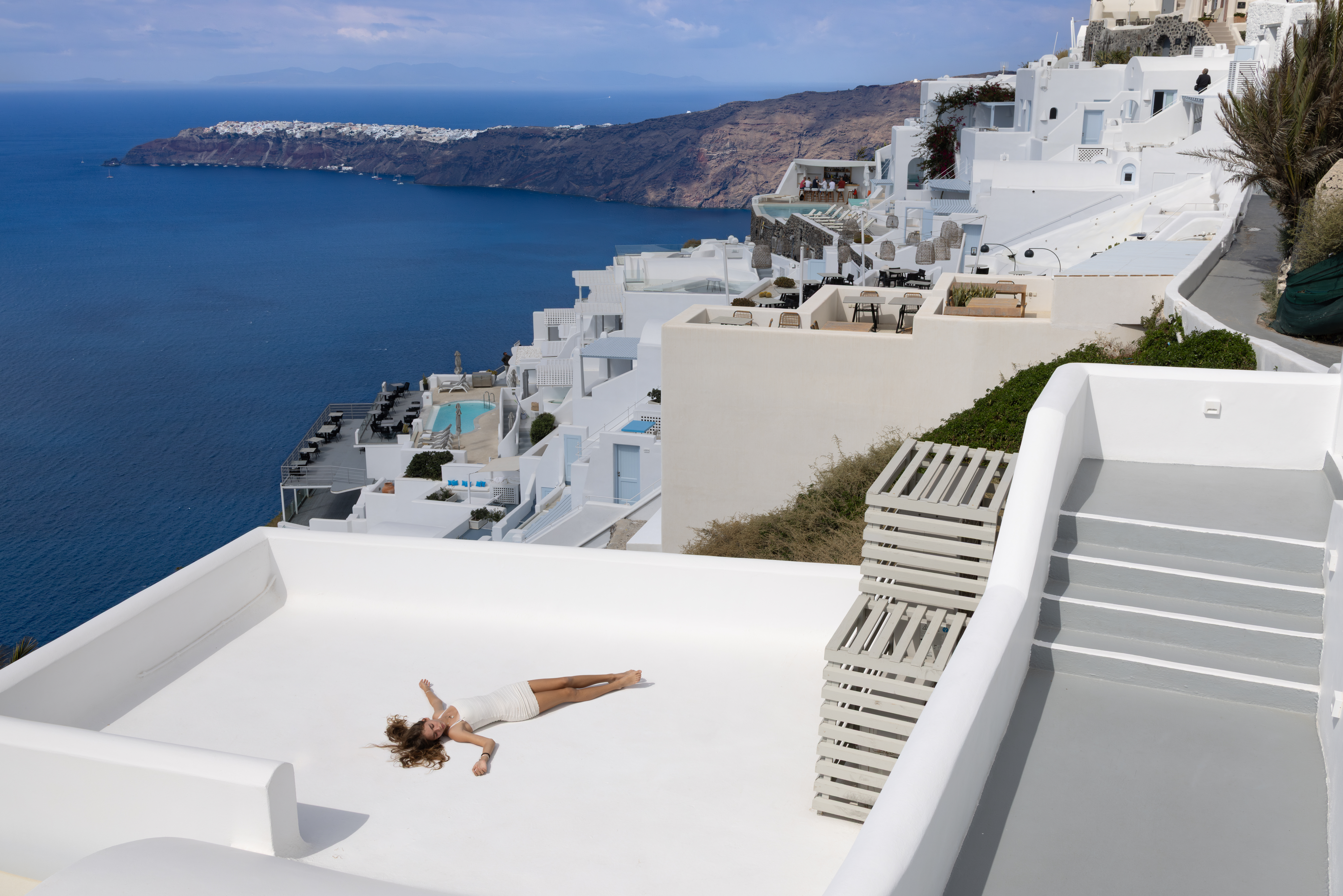 The anatomy of a brilliant Greek island‑hopping itinerary: ferries, pacing and comfortable stays 3 young girl relaxing santorini greece a145ffa0381c359200b1 BTOURS