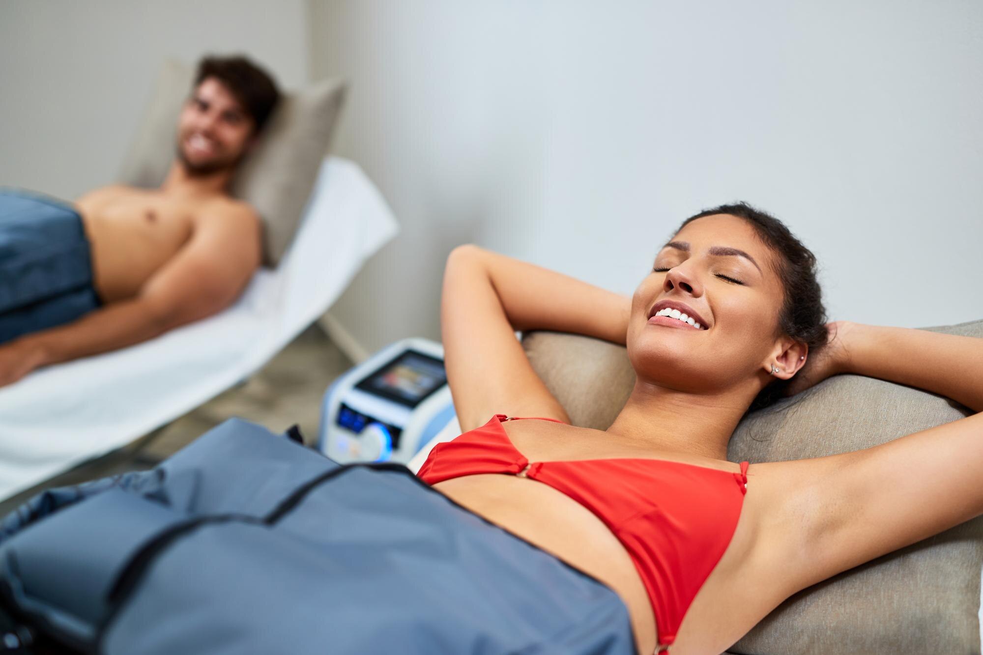 young happy woman enjoying in pressotherapy while 3aa646c8bcf5f1f724e7