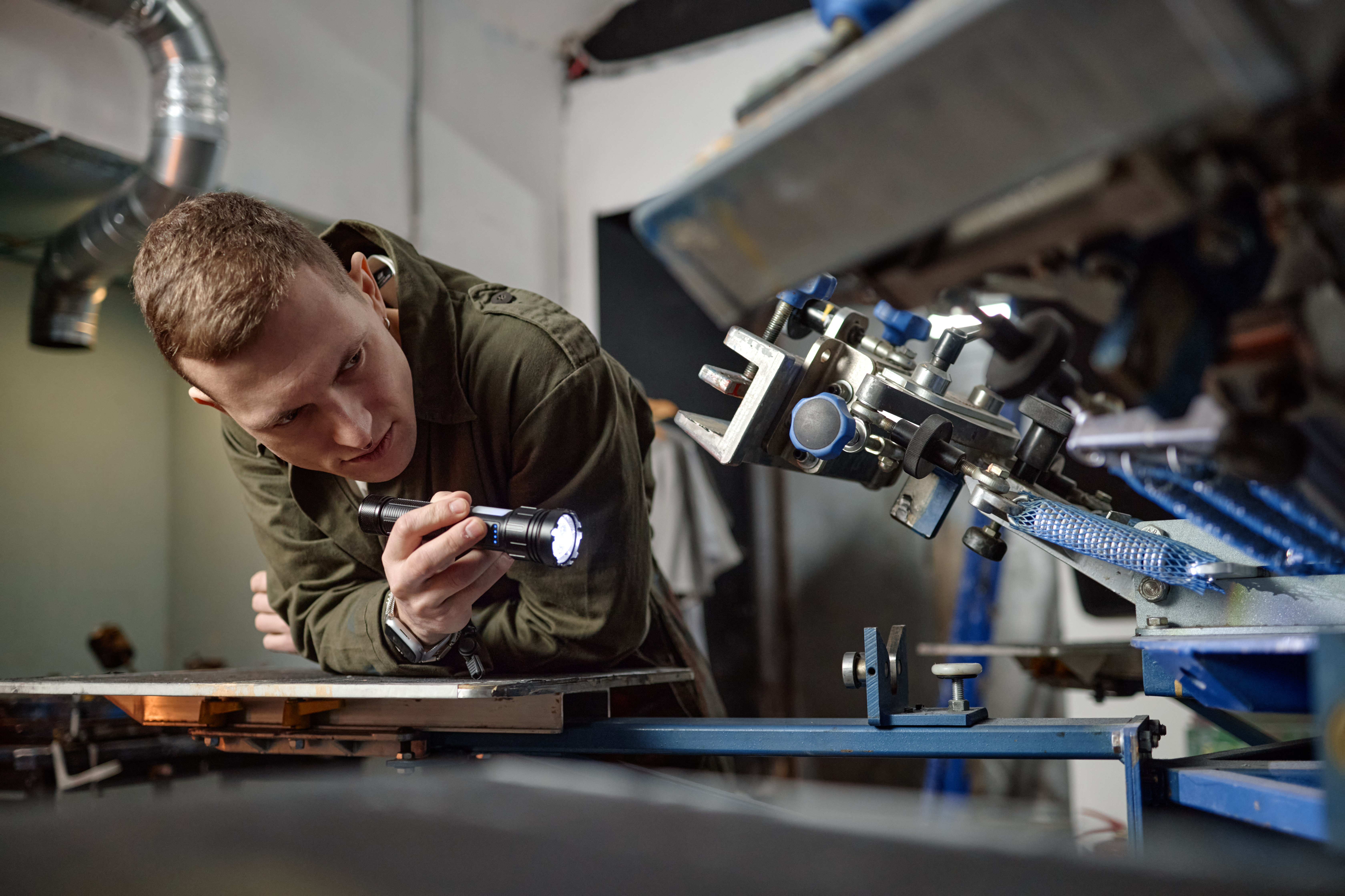 How Local Plastic Fabrication Ensures Consistent Quality and Customer Confidence 1 young man inspecting industrial machinery with fla f3849a4e17a7a963b673