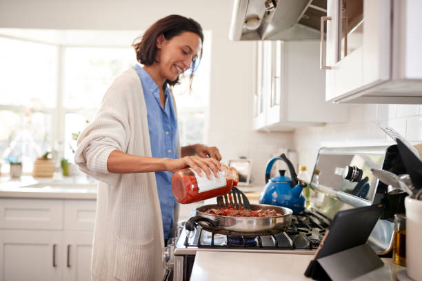Young Mixed Race Adult Woman Standing In The Kitch 518F02C460880E9D2C06