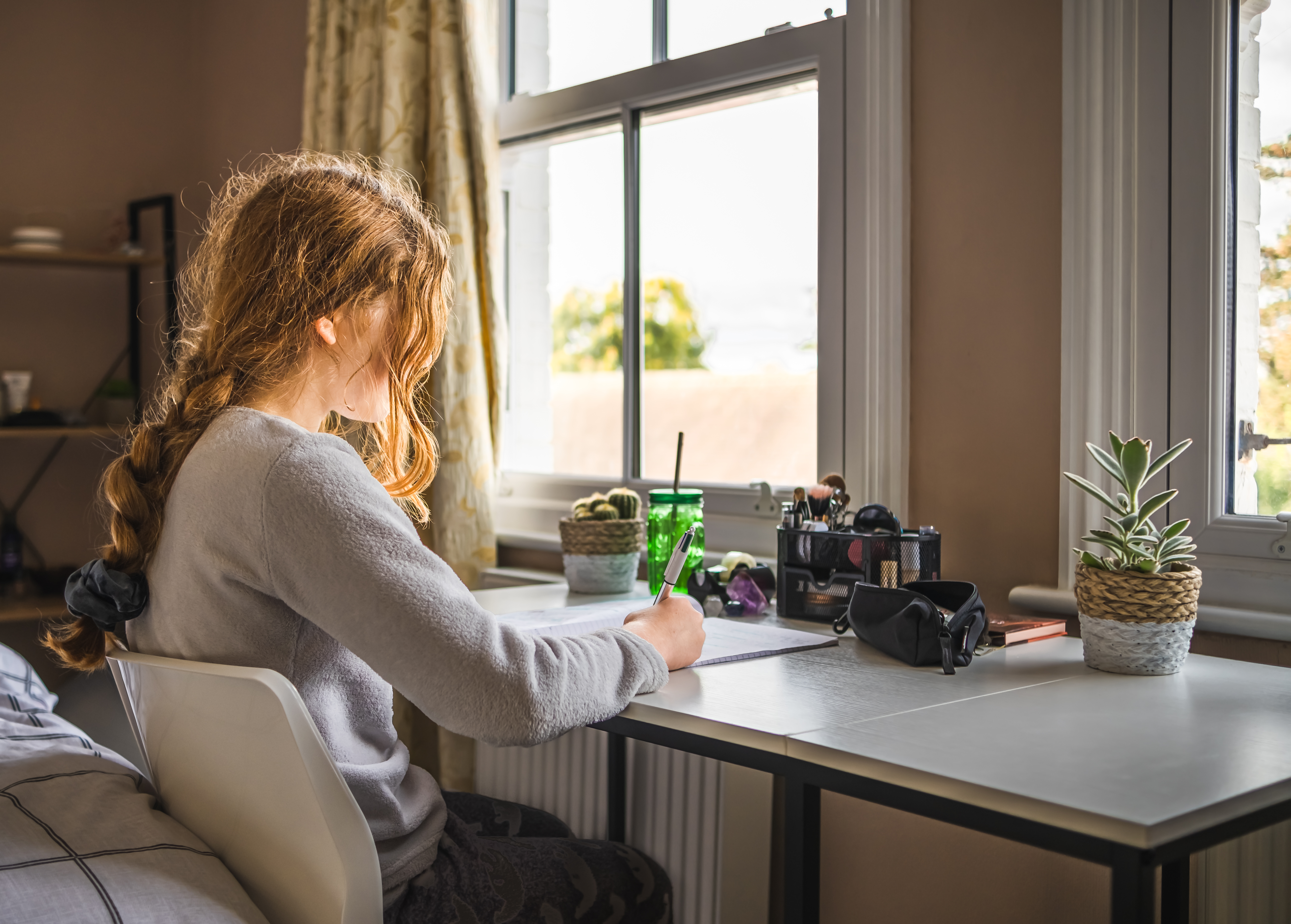 Young Teenage Girl With Long Braid Studying At Her C5c75d803584a20f2c98