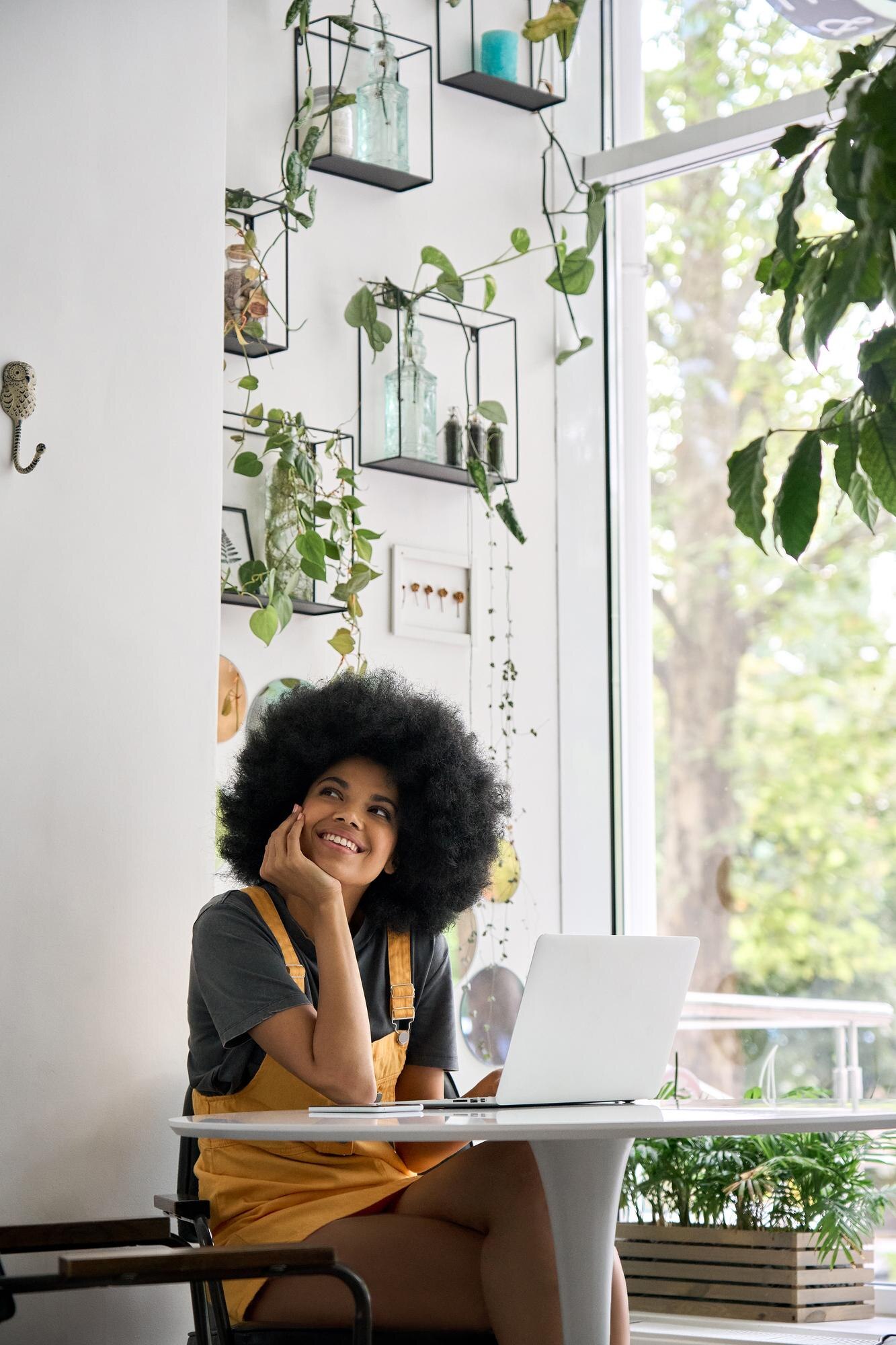 young thoughtful happy black girl sitting in cafe 8b81bcc2fa657b189cef