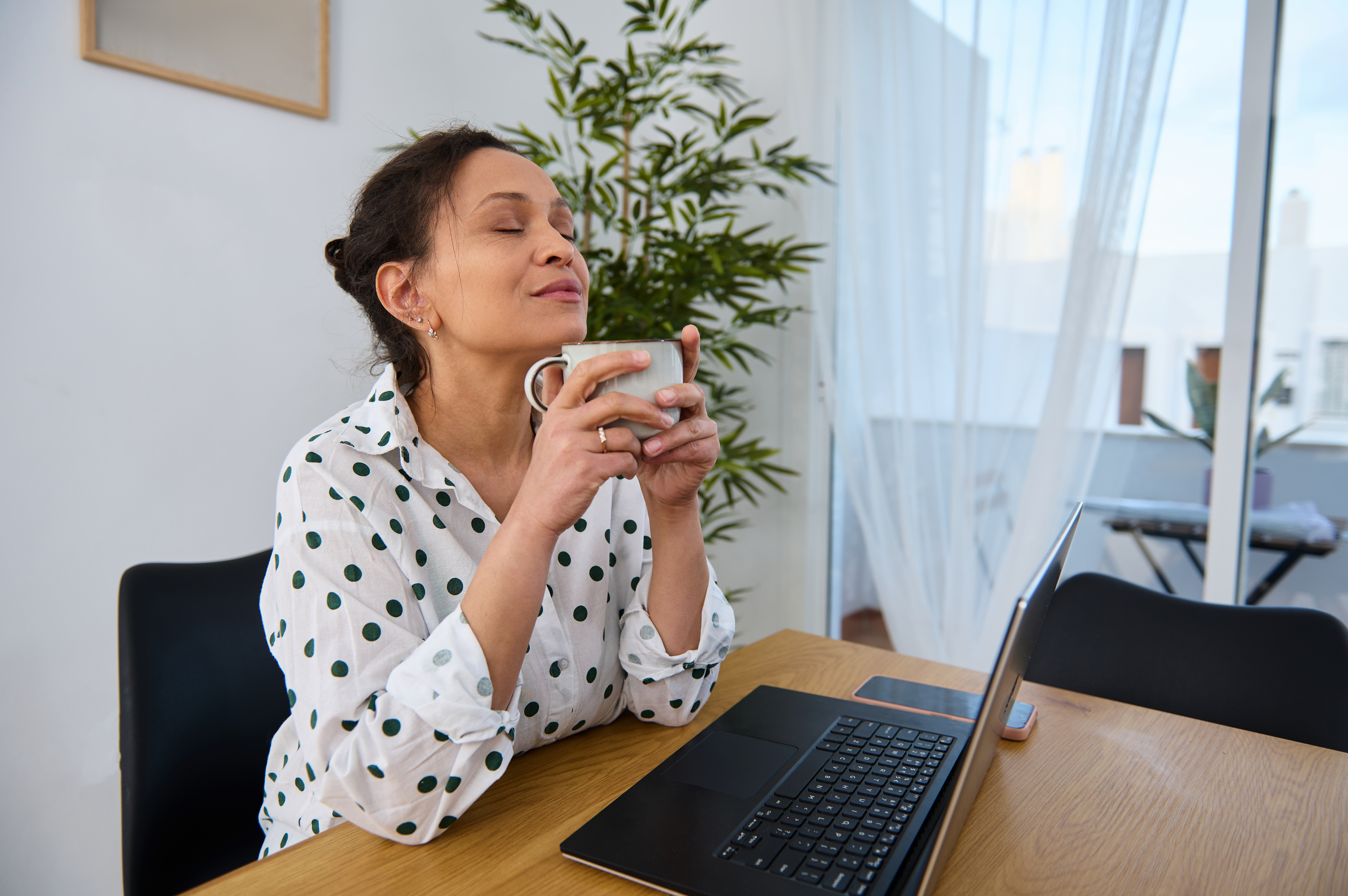 Simple Daily Rituals To Tame The Social Media Beast 3 Young Woman Enjoying Coffee While Working Remotely Cb13Fc6Aa8F286E4B9Ec