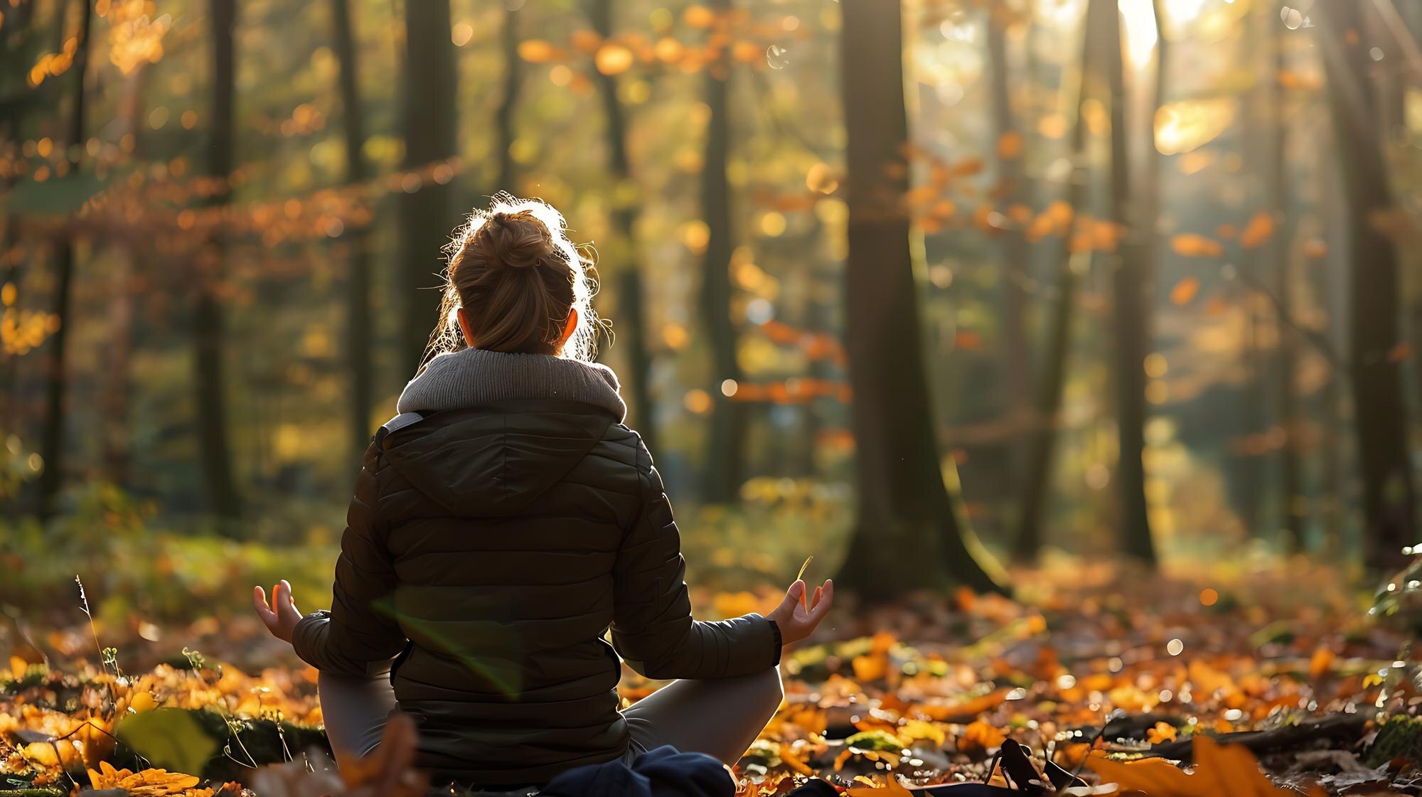 young woman in a green jacket sits in a yoga pose 308758046e6dae796afc