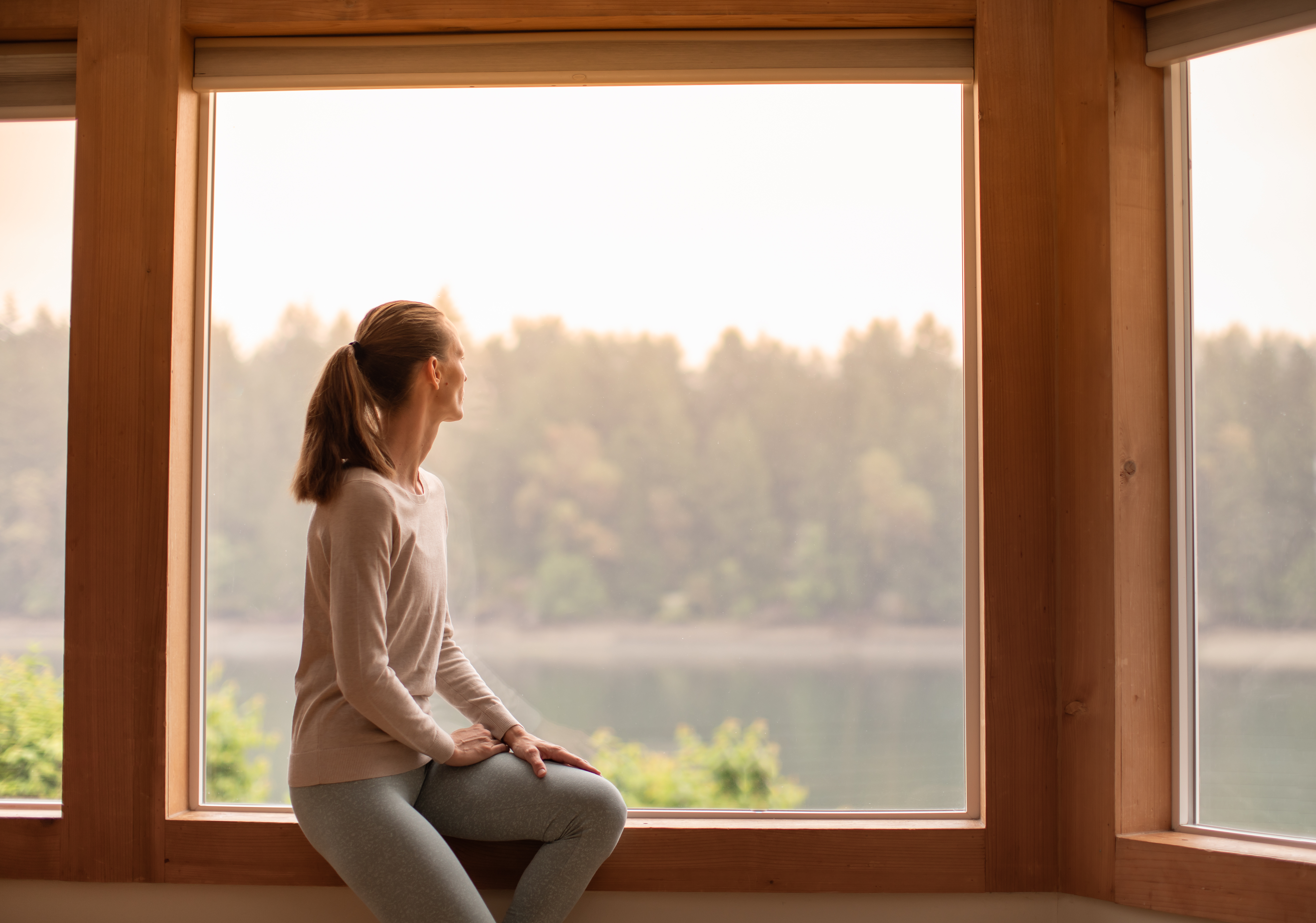 young woman looking out a window feeling calm and d3919146bfe9d1f85ddb