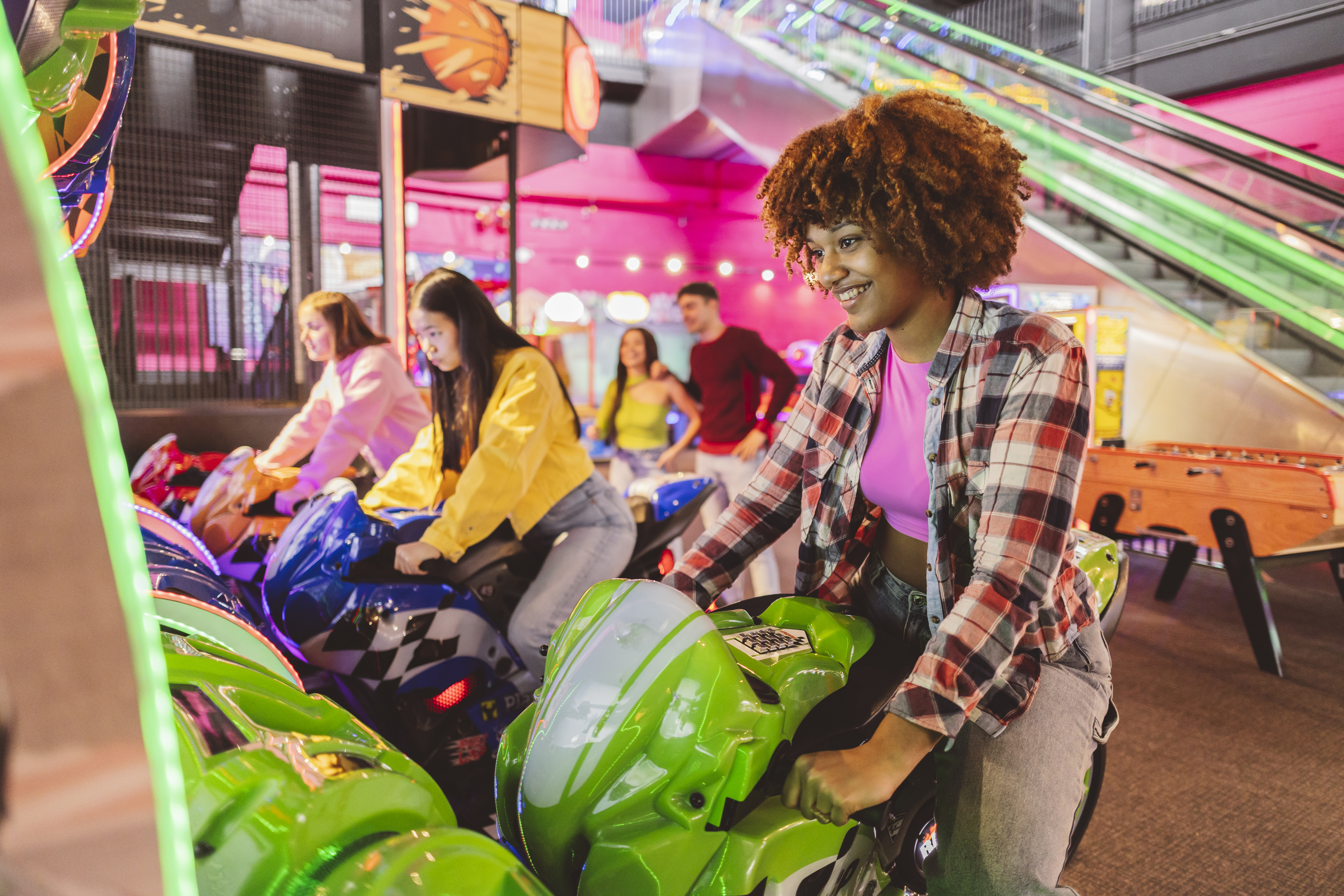 young woman on a motorcycle arcade game at a funfa 4993a4223a1e54844ea8