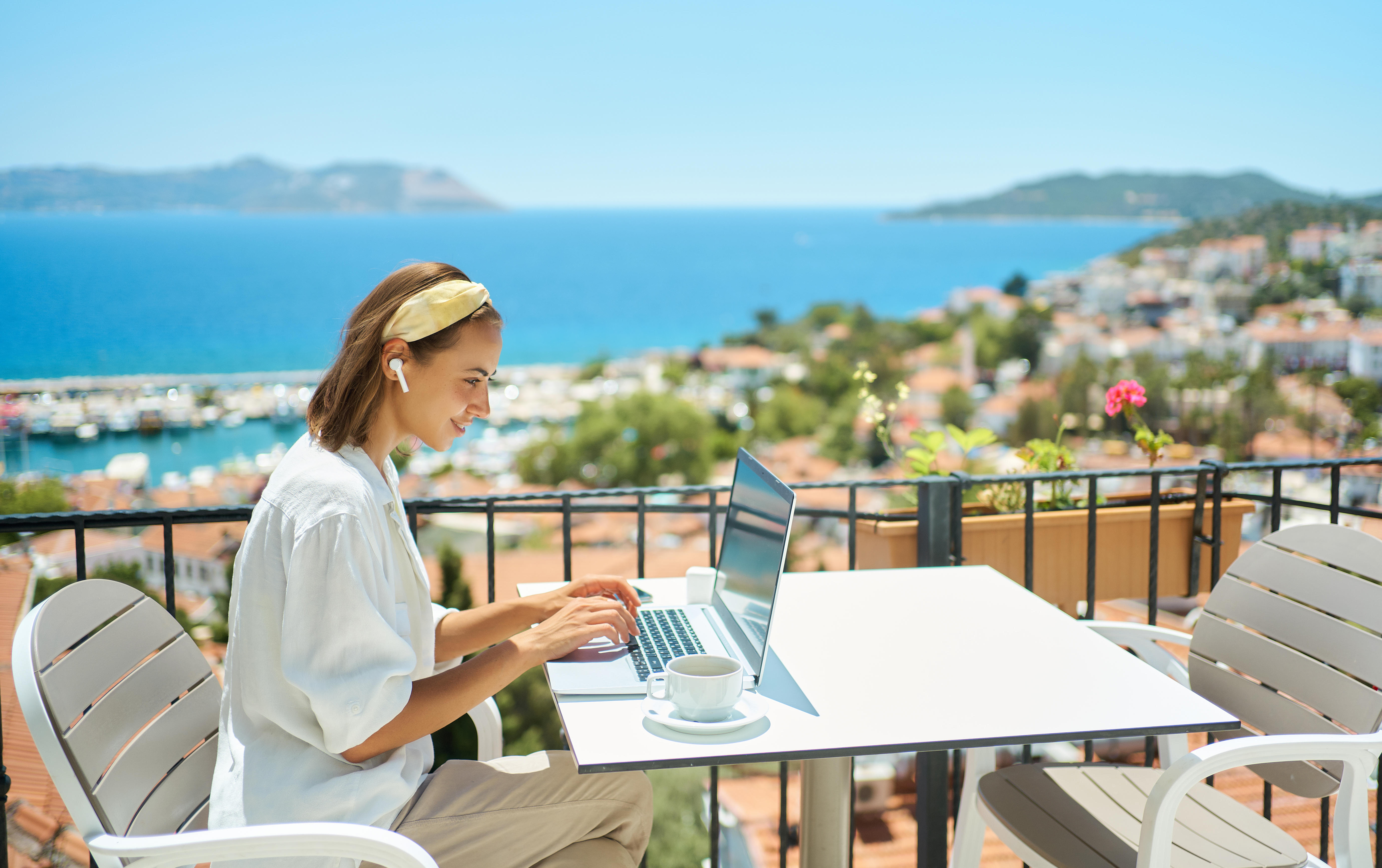 Unlocking Wellness: Travel Tips for the Busy Woman Entrepreneur 2 young woman using laptop computer at cafe balcony 213133b2e7288b3df5e9