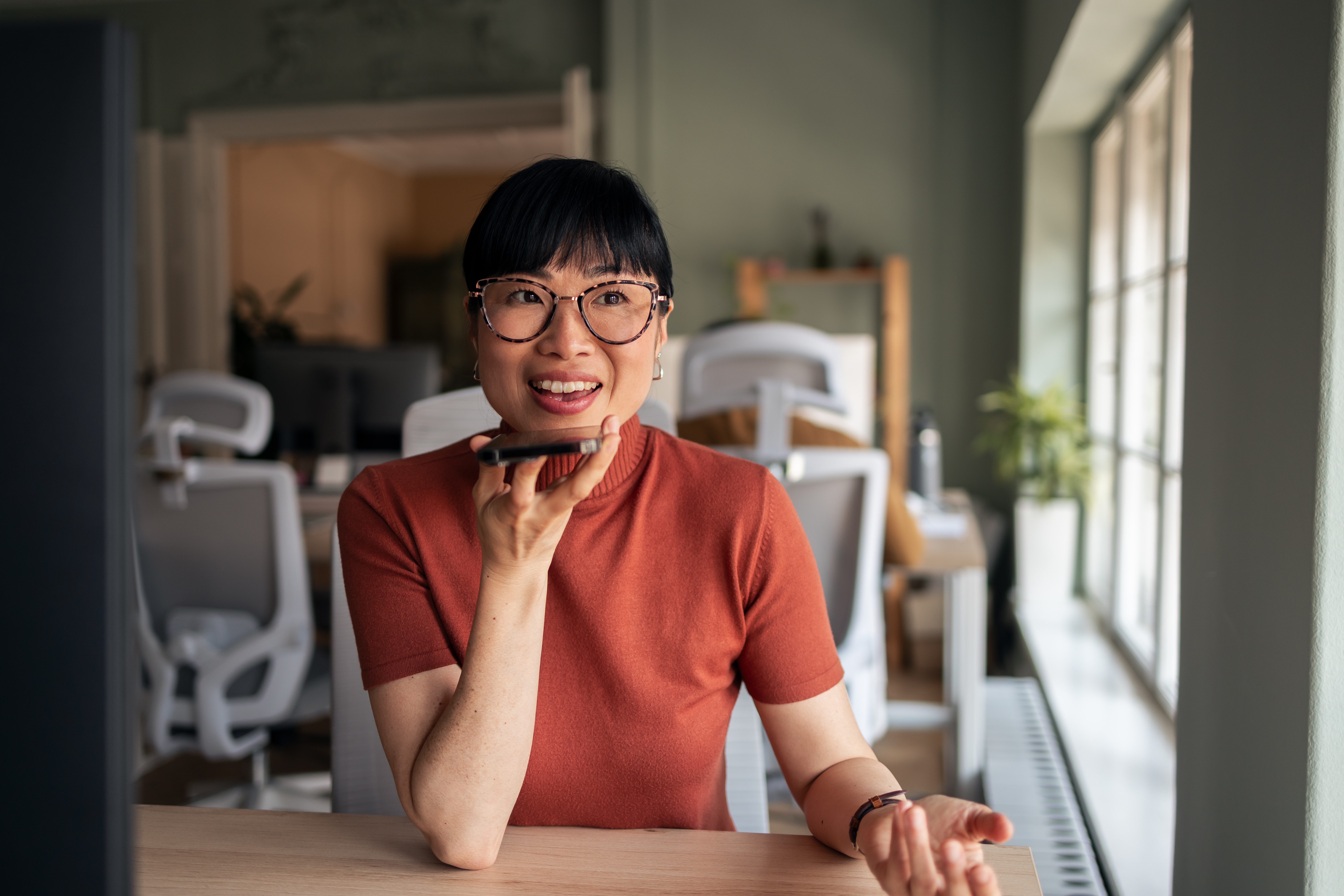 young woman using smartphone voice feature in a mo ac64f7a267eb0c892ad3