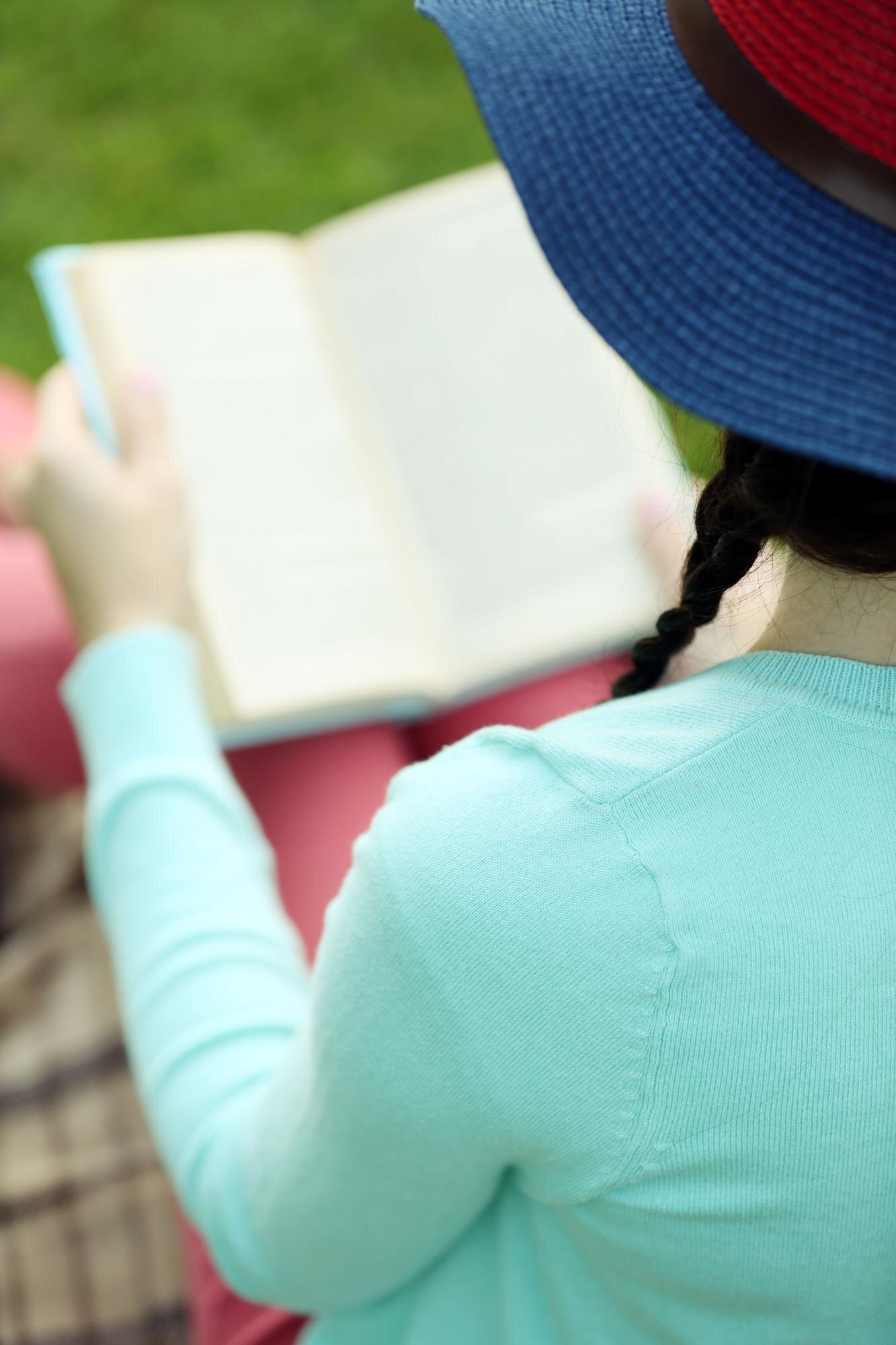 Young Woman With Book Sitting On Green Grass Outdo 5d7582d132529e5cafee